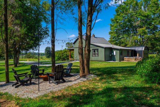 Seating around the fire pit with the house behind.
